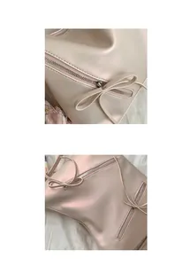 Detail of light pink faux leather tote bag with bow accent and silver zipper closure