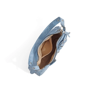 Close-up of light blue denim texture bag with silver buckles and brown fabric lining
