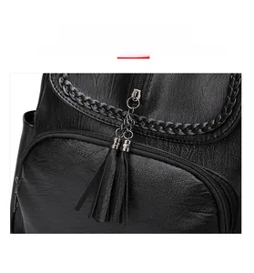 Dettaglio dello zaino in pelle PU nera con motivo intrecciato e nappa in pelle