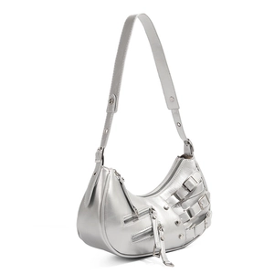 Detailed view of silver metallic crescent bag with punk style zippers and metal rivets