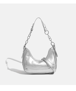 Detail of silver metallic hobo bag featuring glossy finish and elegant chain strap