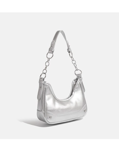 Detail of silver metallic crescent underarm bag with chain strap and stud accents