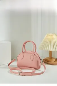 Pink Boston bag detail showing smooth matte leather texture and elegant hand straps