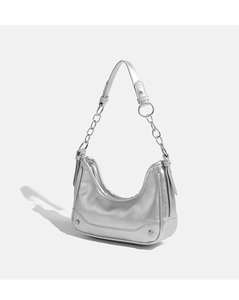 Close-up of metallic silver hobo bag with crinkled texture, chain strap and rivet details