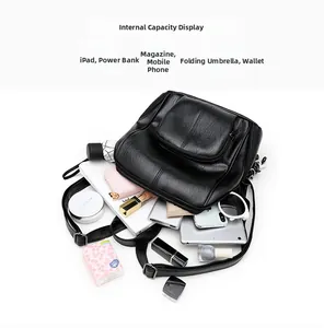 Detailed capacity view of a black lychee leather backpack with daily essentials