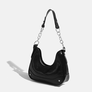 Elegant black underarm baguette bag with silver rivets and metallic chain strap
