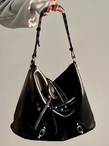 Close-up of black leather Hobo bag featuring silver rivets and adjustable buckle strap