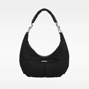 Detail of black nylon crescent bag showing quilted texture and silver metal chain hardware