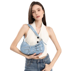 Light blue washed denim hobo bag in Y2K motorcycle style with silver metal hardware