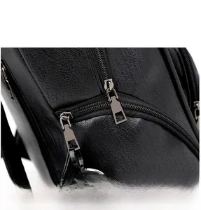 Detail view of smooth gunmetal double zippers on black pebbled leather backpack
