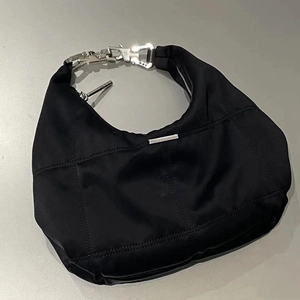 Detailed top view of black nylon crescent bag with industrial silver metal lock handle