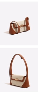 Dettaglio ravvicinato di tela e pelle marrone su una borsa a spalla baguette vintage