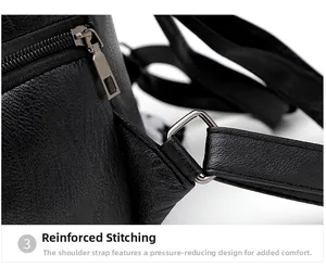 Detail of reinforced stitching and metal zipper on black litchi grain leather backpack