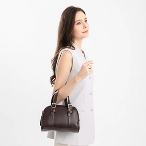 Retro dark brown Boston handbag in smooth leather shown on model for elegant daily styling