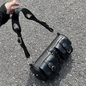Black punk-style cylinder bag with silver metal eyelets and multiple buckles