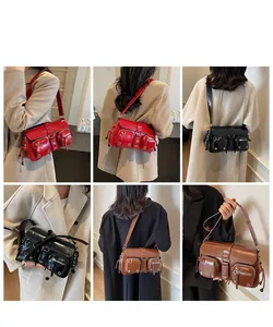 Detail view of multi-pocket vintage baguette bags in red, black, and brown faux leather