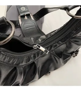 Detail of the smooth metallic zipper and high-quality PU leather texture of the black bag