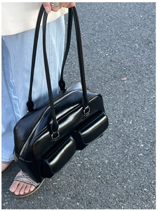 Detail of vintage black oil wax leather bowling bag featuring double front flap pockets