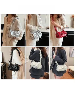 Detail of pleated shoulder bag with large bow in silver, red, black, and beige colors