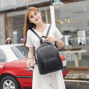Chic black soft leather backpack for women with a cute doll pendant for casual street style
