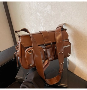 Brown vintage faux leather baguette bag featuring silver rivet hardware and multiple pockets