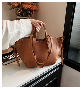 Brown litchi grain leather tote bag with white contrast stitching and dual straps