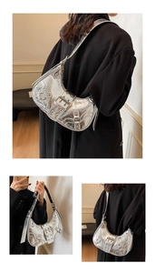 Silver metallic crescent motorcycle shoulder bag with trendy buckles and cool style for women.