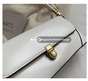Close-up of vintage white PU leather bag with brass twist lock and dark edge painting