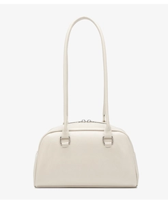 Detailed close-up of cream oil-wax leather bowling bag with silver metal buckles