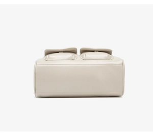 Detailed bottom view and front pockets of a cream oil wax leather bowling shoulder bag