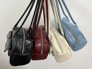 Detail view of four color options for the oil wax leather shoulder bag with side pockets