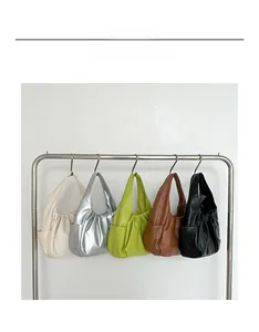 Detailed collection of croissant hobo bags in five colors hanging on a metal display rack