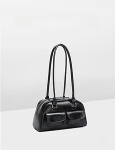Detail of vintage black oil wax leather handbag featuring double front flap pockets