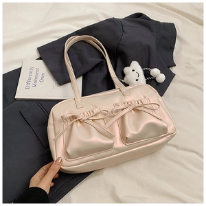 Close-up of beige satin tote bag featuring bow accents and ruffled pockets for women