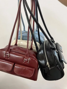 Polished oil wax leather bowling bags shown in burgundy, cream, blue, and black colors