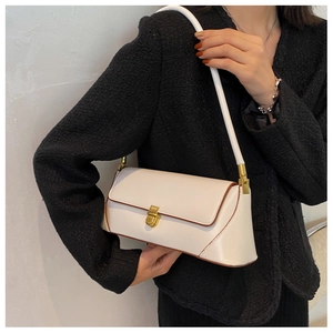 Detail of white baguette shoulder bag with gold metal buckle and brown edge paint