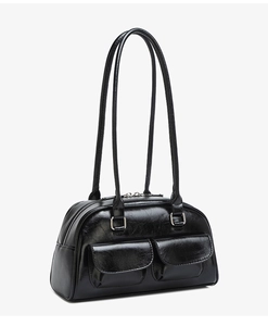 Detail of black oiled leather bowling bag with front flap pockets and silver zippers