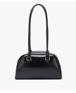 Close-up of black waxed leather handbag showing shiny texture and silver hardware