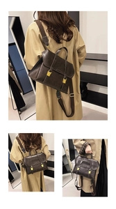 Detail of vintage brown leather satchel with adjustable strap and metal buckles