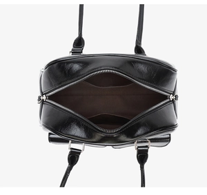 Close-up of the black waxed leather handbag interior with spacious pockets and dark lining