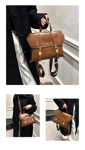 Detail of vintage brown leather bag with bronze buckles and convertible straps