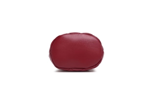Detail view of the quilted burgundy leather base and stitching of the bucket bag