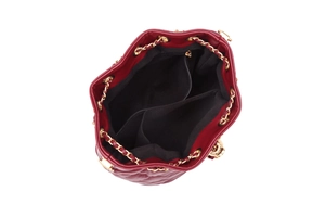 Top view showing the internal compartments and black lining of the red quilted bucket bag