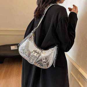 Silver metallic crocodile pattern crescent shoulder bag with stylish metal rivets and buckles.