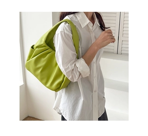Close-up of lime green pleated hobo bag featuring soft texture and stylish shoulder drape