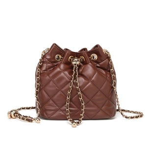 Brown quilted leather bucket bag with gold chain strap and drawstring closure