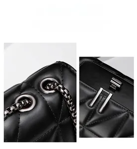 Detailed macro view of black quilted leather texture and polished gunmetal hardware