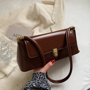 Deep brown vintage leather baguette bag with gold metal buckle and sleek shoulder strap