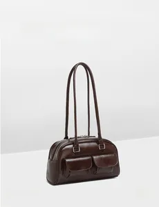 Detail of dark brown wax leather boston bag with double front magnetic flap pockets