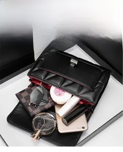 Detailed interior of a quilted flap bag showing organized compartments for daily essentials